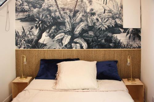 um quarto com uma grande tapeçaria por cima de uma cama em Joli 2 pièces sur le port avec piscine, terrasse, parking em Capbreton
