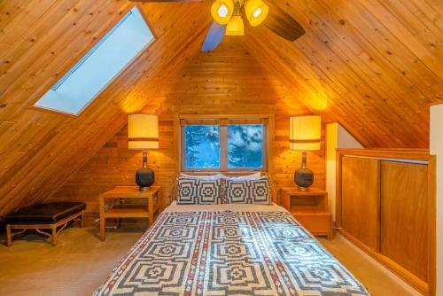 a bedroom with a bed in a wooden house at Cozy Cabin Perched on the Mountainside - Alpine Haus in Alma