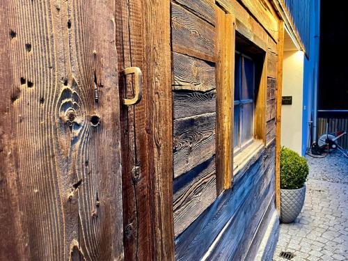 a wooden door with a window on the side of a building at Hof Ida in Bach