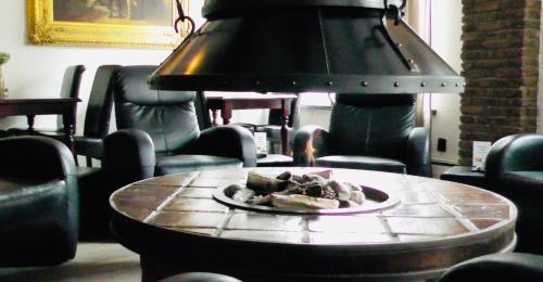 a plate of food on a table in a room with chairs at Wellnesshotel Spabron in Wachtum