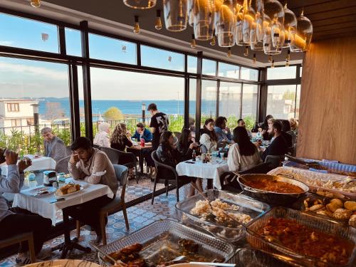 a group of people sitting at tables in a restaurant at PALMERA OLD CITY in Istanbul