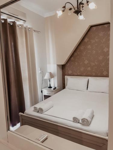 a bedroom with a large bed with a large mirror at Elena Rista Studios in Parga