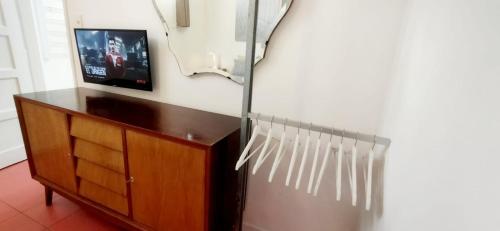 a room with a refrigerator and a tv on a wall at House with large terrace, jacuzzi and gated parking for one car in Montevideo
