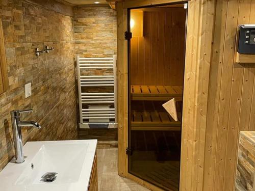a bathroom with a white sink and a shower at À louer : Ancienne forge avec sauna, piscine, proche plage et sites historiques - FR-1-591-193 in Le Menoux
