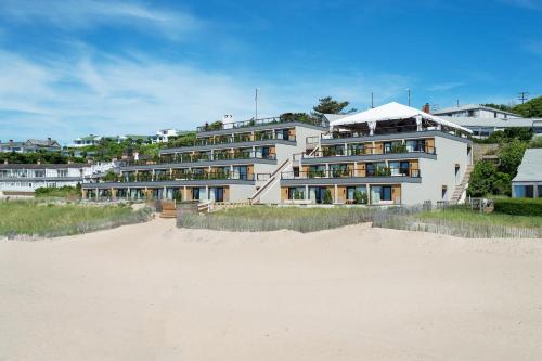 a large white building on the beach next to the sand at Gurney's Montauk Resort & Seawater Spa in Montauk