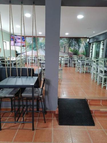 a dining room with a table and chairs in a restaurant at D'aqui e D'acolá - Pardieiros in Pardieiros