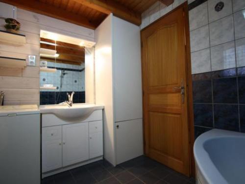 a bathroom with a sink and a toilet and a tub at Gîte Le Val-d'Ajol, 2 pièces, 4 personnes - FR-1-589-135 in Le Val-dʼAjol