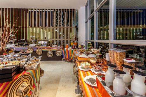 a room with several tables with vases on them at Sonesta Valledupar in Valledupar