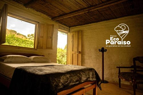 a bedroom with a bed and a window with a sign at Finca Ecoparaiso in Ibagué