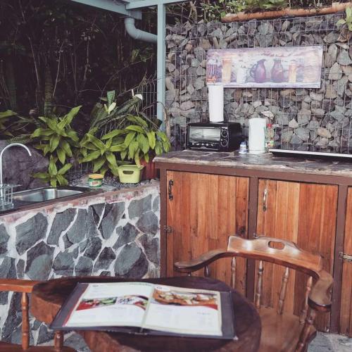 a kitchen with a counter and a sink and a table at Domos Mirador Romantic Private Honeymoon Glamping in Miramar