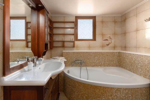 a bathroom with a tub and a sink at Green Sunshine in Theologos