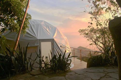 a white tent with a door in the middle at Domos Mirador Romantic Private Honeymoon Glamping in Miramar