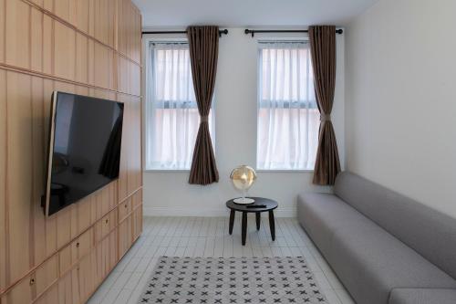 a living room with a couch and a tv at Trueman Court Luxury Serviced Apartments in Liverpool