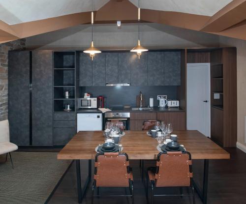 a kitchen with a wooden table and chairs at Trueman Court Luxury Serviced Apartments in Liverpool