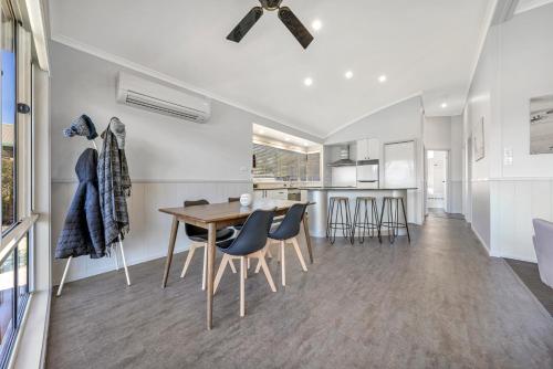 a dining room and kitchen with a table and chairs at Ingenia Holidays Merry Beach in Kioloa