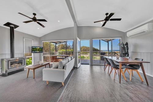 a living room with a couch and a table and a fireplace at Ingenia Holidays Merry Beach in Kioloa