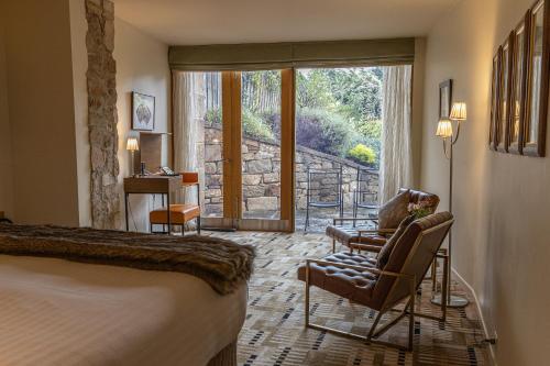 a hotel room with a bed and a chair and a window at Islington Hotel in Hobart