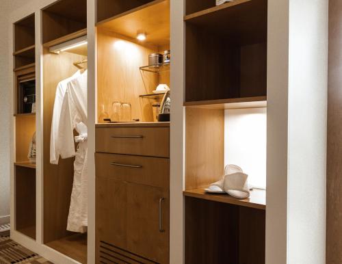 a walk in closet with wooden cabinetry at Islington Hotel in Hobart