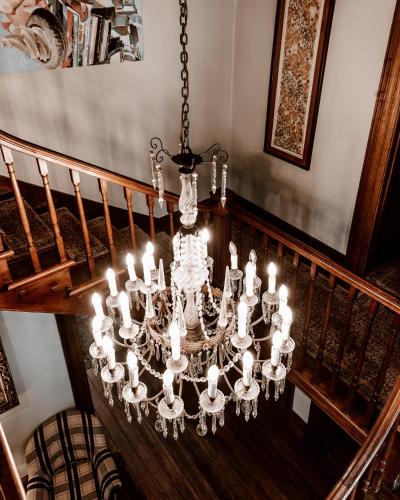 a chandelier hangs from a staircase in a house at Islington Hotel in Hobart