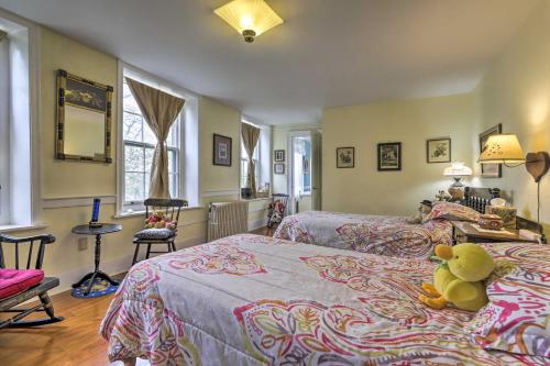 a teddy bear sitting on a bed in a bedroom at Elegant Norwich House with Billiards Room and Ballroom in Norwich