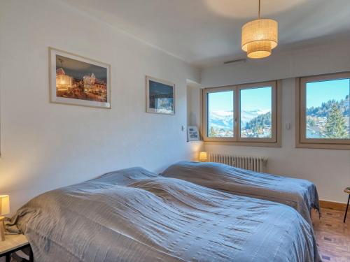 une chambre avec un lit et deux fenêtres dans l'établissement Appartement rénové, centre Megève, 1 chambre + cabine, proche télécabine, 5 pers. - FR-1-453-280, à Megève