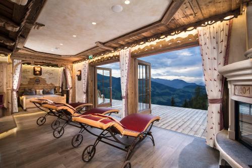 a room with a view of a bedroom and a fireplace at Luxus Chalet Bischofer- Bergwelt in Alpbach