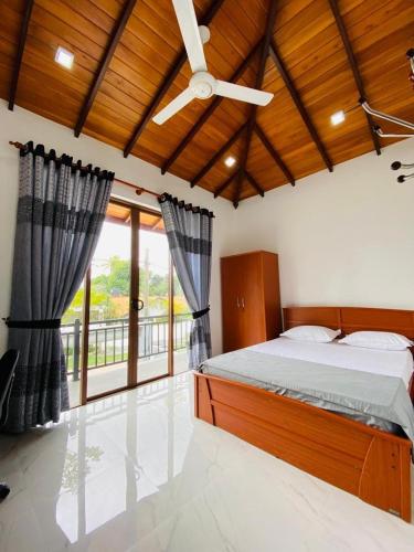a bedroom with a bed and a ceiling fan at Happy Homes in Kiribathgoda