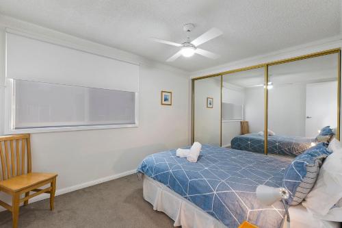 a bedroom with two beds and a large window at Regency Court 4 in The Entrance