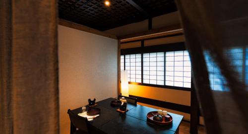 a dining room with a table and a window at Izumiya Zenbe in Matsumoto