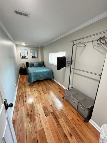 a bedroom with a bed in a room with wooden floors at Atlanta Unit 2 Room 3 - Atlanta Bests Kept Secret Private Bedroom & Bathroom in Atlanta