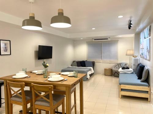 a living room with a table and a couch at CRIB 227: Modern Fresh Vibe Condo in Olongapo
