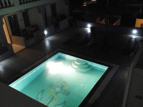 a swimming pool in the middle of a room at Grande Murano in Fira