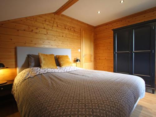 a bedroom with a bed and a wooden wall at Gîte Rupt-sur-Moselle, 4 pièces, 6 personnes - FR-1-589-387 in Rupt-sur-Moselle