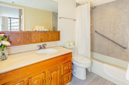 a bathroom with a sink and a toilet and a shower at Waikiki Sunset Tropical Getaway with Free Parking! in Honolulu