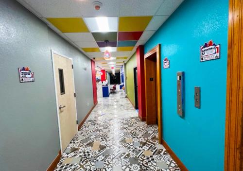 a hallway with colorful walls and a long hallway with a hallway at Philly Inn & Suites in Philadelphia