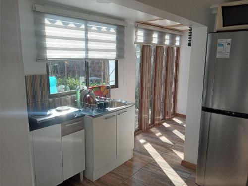 a kitchen with a sink and a window at Tu Jardín Secreto in La Serena