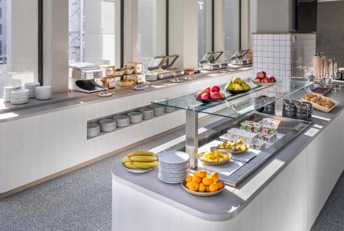 a buffet line with fruits and vegetables on display at Holiday Inn Express Auckland City Centre by IHG in Auckland