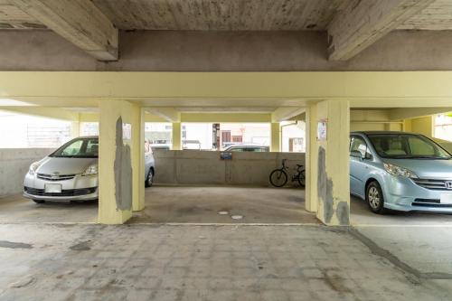 two cars are parked in a parking lot at M`Sリゾート若狭@LiB PLUS in Tomari