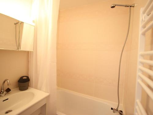 a white bathroom with a shower and a sink at Appartement Chamrousse, 2 pièces, 5 personnes - FR-1-549-83 in Chamrousse