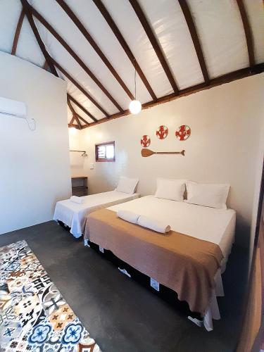 a bedroom with two beds in a room at Pousada Ventos do Norte in Barra Grande