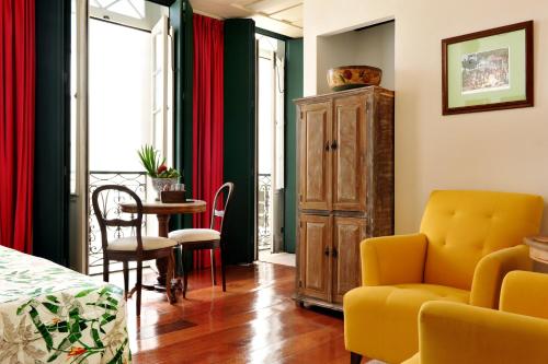 a living room with a yellow chair and a table at Hotel Villa Bahia in Salvador