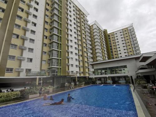 a large swimming pool in front of some buildings at Mesaverte Residences Afs Suites - Studio in Cagayan de Oro