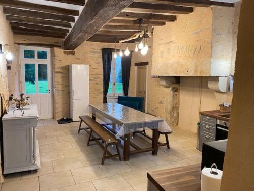 a kitchen with a table and a kitchen with a counter at Château XIXème près du Mans : Piscine, Parc, Proche Forêt et Cité Médiévale - FR-1-410-354 in Parennes