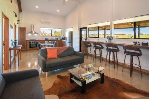 a living room with a couch and a table at Rosa Glen Retreat - Margaret River in Rosa Glen