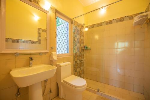 Un baño con un inodoro blanco y un lavabo. en Bamboo Grove by VEO - Part of StayVista, en Dehradun