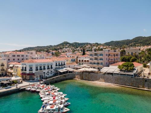 a group of boats are docked in a harbor at Hotel Roumani in Spetses