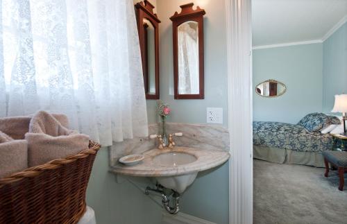 a bathroom with a sink and a bedroom with a bed at Inn San Francisco in San Francisco