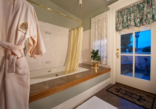 a bathroom with a bath tub and a window at Inn San Francisco in San Francisco