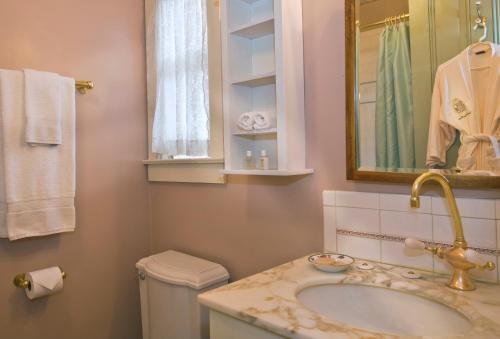 a bathroom with a sink and a toilet and a mirror at Inn San Francisco in San Francisco
