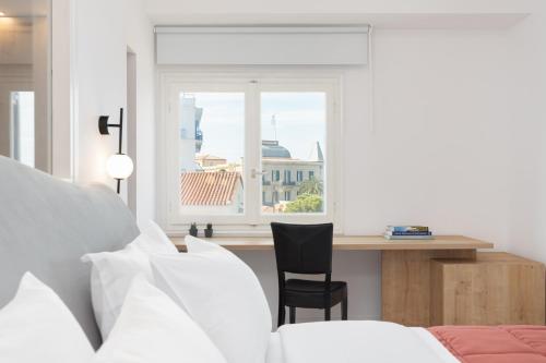 Ένα ή περισσότερα κρεβάτια σε δωμάτιο στο Hotel Roumani